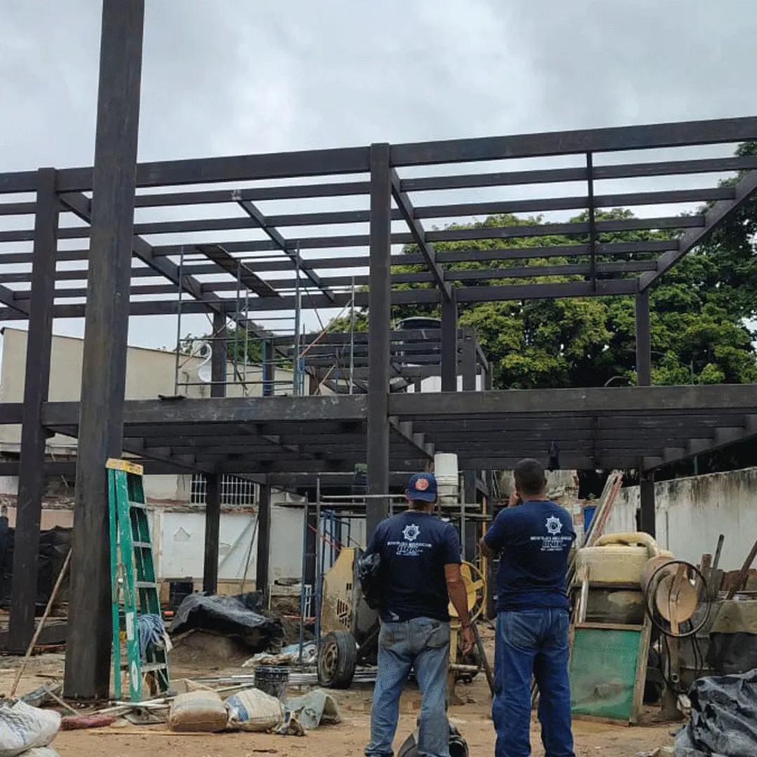 ONIX crew reviewing a two-level structure on site.