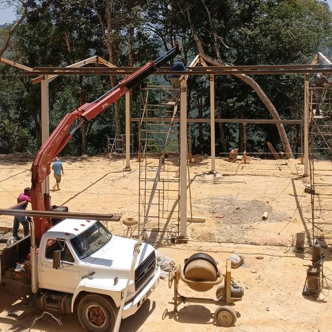 Truck crane lifting a beam during structural erection