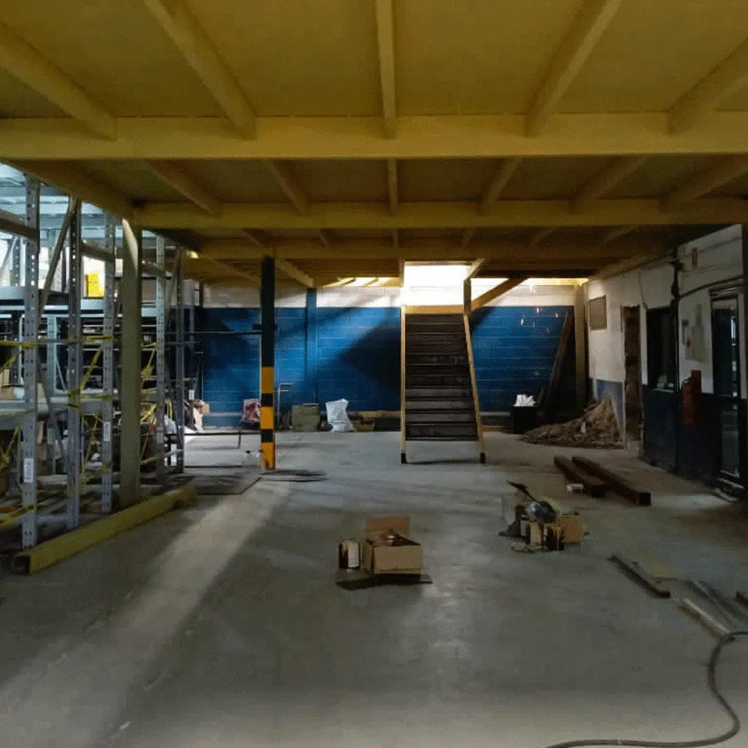 Building interior with a mezzanine and yellow stair