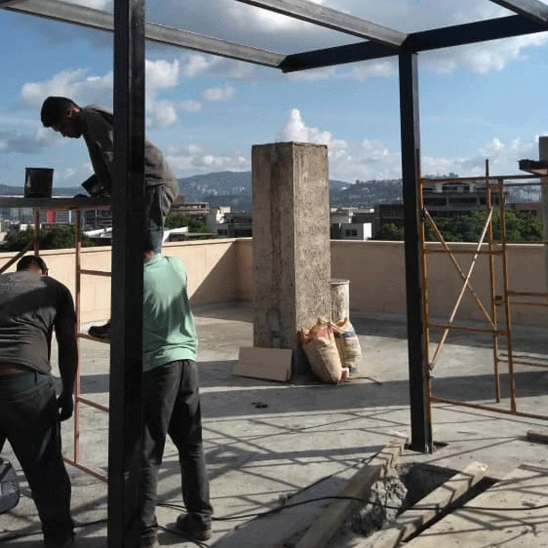 Steel structure being erected on a rooftop terrace