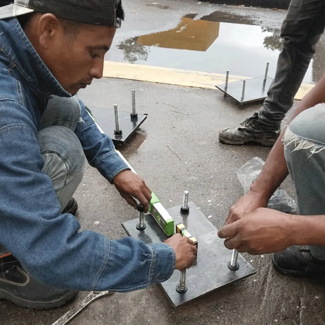 Base plate leveled before the column is plumbed.