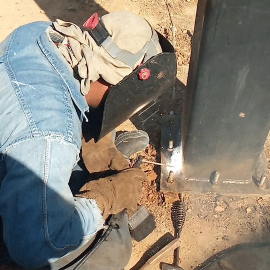 Welder running a joint on the base plate of a column
